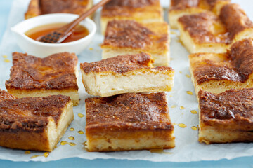 Cinnamon honey cheesecake pie cit into squares - obrazy, fototapety, plakaty