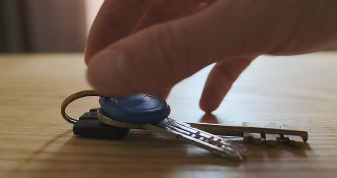 Hand Takes The Keys To The Apartment From The Table. Close-up. The Concept Of Home Security, Apartment Protection, Everyday Life, Forgetfulness