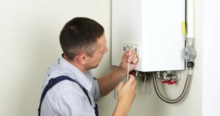 A plumber is attempting to fix a residential heating problem.