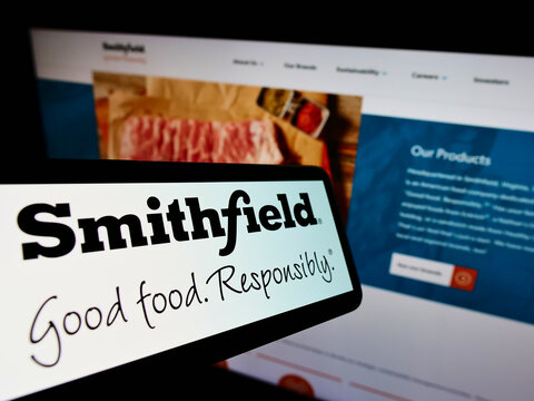 Stuttgart, Germany - 01-08-2022: Cellphone with logo of US food processing company Smithfield Foods Inc. on screen in front of website. Focus on center-right of phone display.