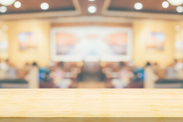 Empty wood table top with cafe restaurant interior blurred background