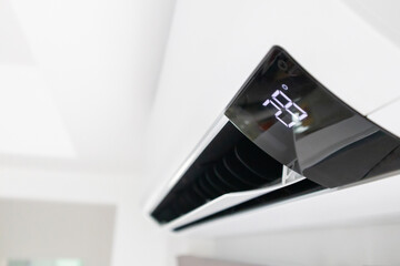 Air conditioner on white wall room interior background