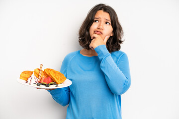 hispanic pretty girl feeling happy, excited and surprised. waffles breakfast concept