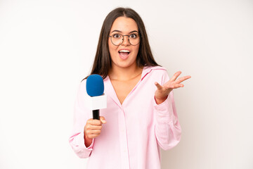 hispanic pretty woma smiling with a happy, confident expression with hand on chin. journalist with...