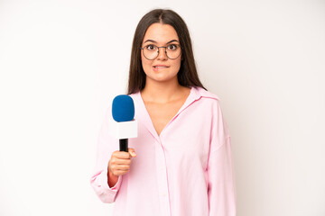 hispanic pretty woma looking serious showing open palm making stop gesture. journalist with a...