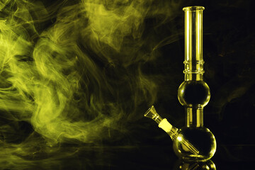 Glass bong and smoke on black background, space for text. Smoking device