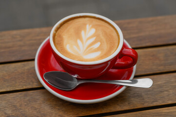 Cup of aromatic coffee on wooden table, closeup