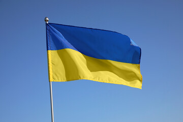 National flag of Ukraine against blue sky