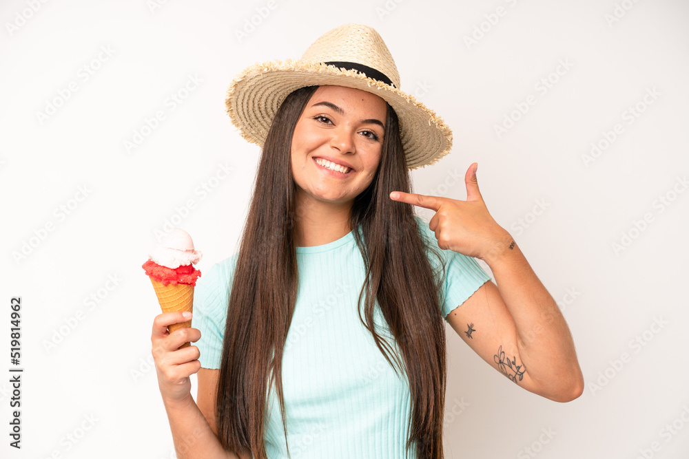 Wall mural hispanic pretty woma smiling happily with a hand on hip and confident. ice cream and summer concept