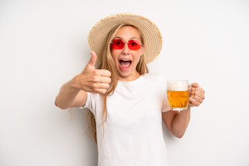 pretty caucasian woman feeling proud,smiling positively with thumbs up. beer pint concept