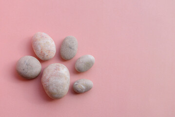 Fototapeta na wymiar Abstract pattern of sea stones. Pink background with place for text.