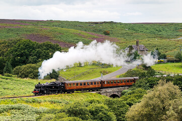 North Yorkshire Moors Railway. Vintage steam locomotive railway engine No.80072 pulls train south from Goathland, England, UK - Powered by Adobe