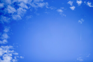 Summer blue sky with white clouds. Blue background with place for text.