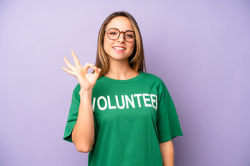 pretty caucasian woman feeling happy, showing approval with okay gesture. volunteer concept