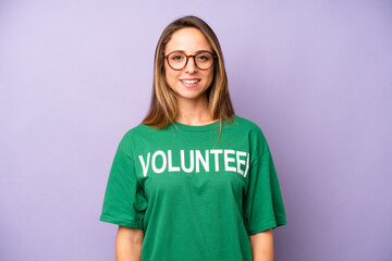 pretty caucasian woman looking happy and pleasantly surprised. volunteer concept