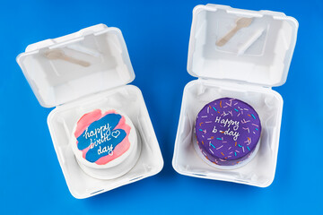 bento cakes A small cakes in a lunchboxes on a blue background. birthday cakes. Asian food trend. Cute gift for any holiday. Copy space
