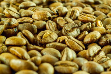Roasted coffee beans in detail under warm lighting