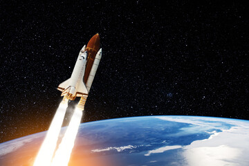 Spaceship lift off. Space shuttle with smoke and blast takes off into the starry sky. Rocket starts into space. Concept. Elements of this image furnished by NASA.