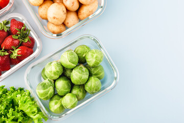 Glass boxes with fresh raw vegetables.  Vegetables and fruits in glass containers. Food storage concept