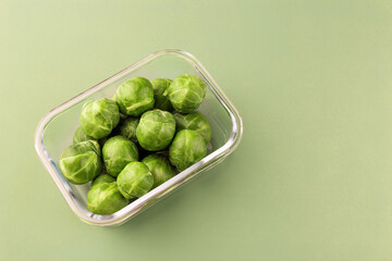 Glass box with fresh brussels sprouts.  Vegetables in a glass containers. Food storage concept