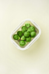 Glass box with fresh brussels sprouts.  Vegetables in a glass containers. Food storage concept