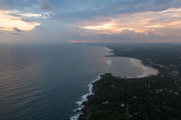 The beach and the ocean during sunset. Dickwella Beach, Sri Lanka.
