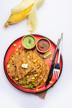 Sweet corn stuffed paratha or parotha served in a plate, Indian flatbread recipe made filling makai