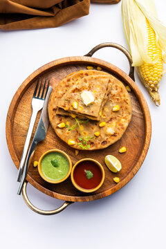 Sweet corn stuffed paratha or parotha served in a plate, Indian flatbread recipe made filling makai