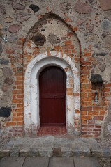 Fototapeta na wymiar Entrance to Church of Assumption of the Blessed Virgin Mary. Chwarstno (village in Lobez County), Poland.