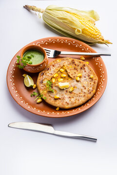 Sweet corn stuffed paratha or parotha served in a plate, Indian flatbread recipe made filling makai