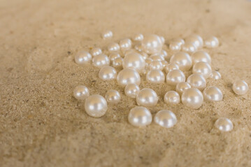 dark blue round pearls on the sand