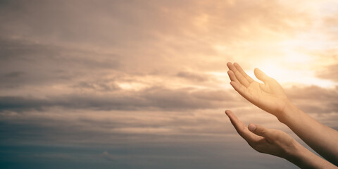 Woman hands praying for blessing from god with sunlight on sunset background..