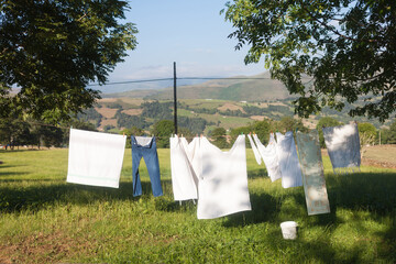 Washed linen for drying against the backdrop of mountains. Mountain summer landscape.