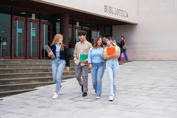 Fototapeta premium Group of college students leaving the library to study