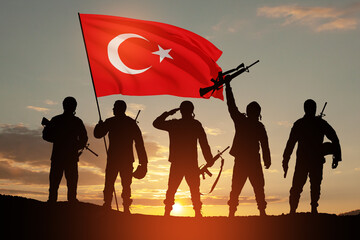Silhouettes of soldiers with Turkey flag against the sunrise or sunset. Concept of crisis of war and conflicts between nations. Greeting card for Turkish Armed Forces Day, Victory Day.