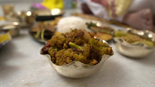 Close up shot of phool gobi  masala along with other dishes in Annaprashan rituals or Mukhe bhaat in Kolkata, India.