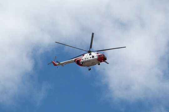 BOGOTA, COLOMBIA - JULY 20 OF 2022 A red and white MI-17 army helicopter flying over crow during colombian independence military parade day