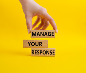 Manage your response symbol. Concept words Manage your response on wooden blocks. Businessman hand. Beautiful yellow background. Business and Manage your response concept. Copy space