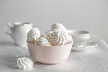 small white meringue in a deep pink plate on a white background
