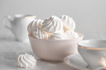small white meringue in a deep pink plate on a white background