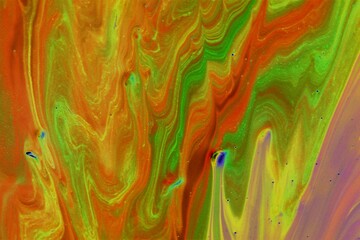Background of green-orange marble. Acrylic paint flows freely and creates an interesting pattern. The effect of natural marble. Background for the cover of a laptop, notebook.