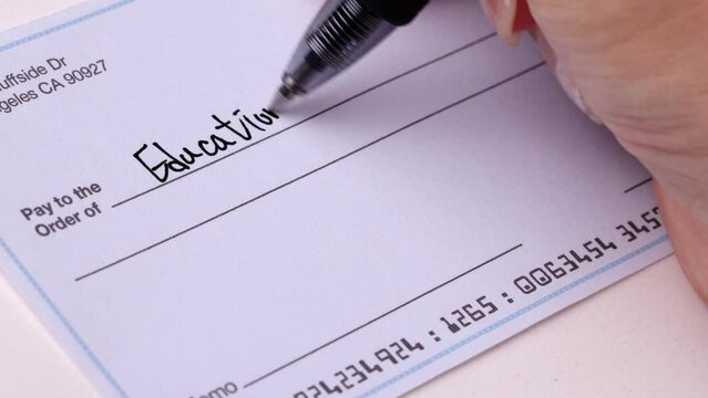 Close-up shot of a check being writen.