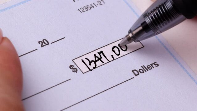 Close-up shot of a check being writen.