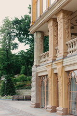 Beautiful architecture with balconies and stairs in a well-kept park, lots of flowers and greenery