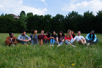 Group of young people from different cultures sitting on the floor having a fun time