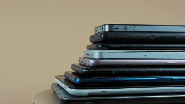 Outdated models of mobile phones and smartphones. Rotation of old smartphones.