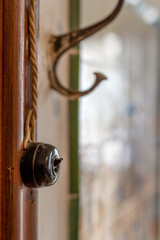 old wall switch and coat rack, vertical photo