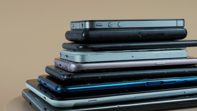 Outdated models of mobile phones and smartphones. Rotation of old smartphones.