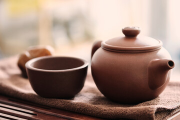 Traditional chinese tea ceremony utensils. Chinese brown clay teapot and cup. Tea brewing equipment