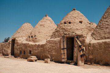 Traditional mud brick made beehive houses. Harran, major ancient city in Upper Mesopotamia, nowadays is a district in Sanliurfa province, Turkiye. Village of beehive houses opposite clear sky